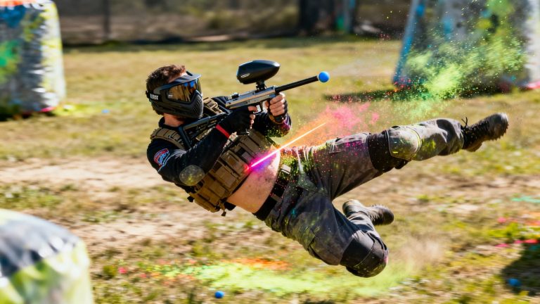 Player performing a cross-body paintball shot.