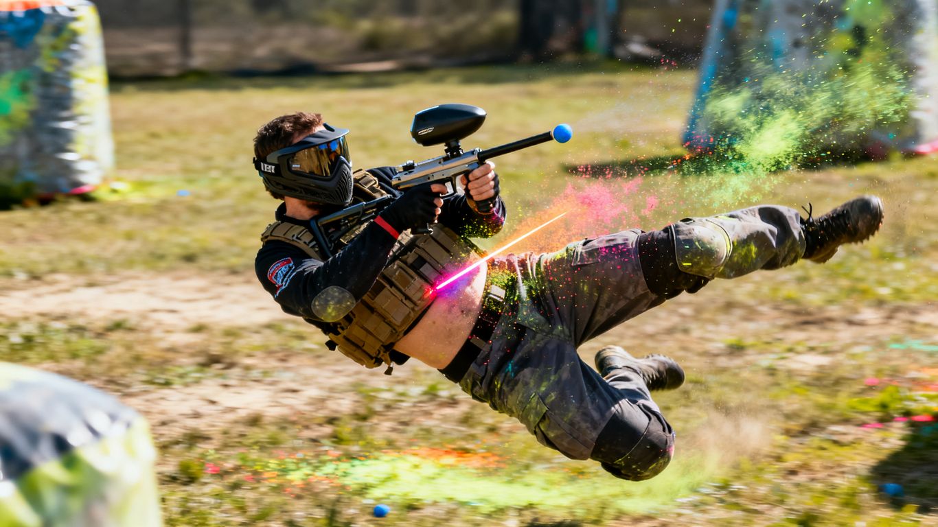 Player performing a cross-body paintball shot.